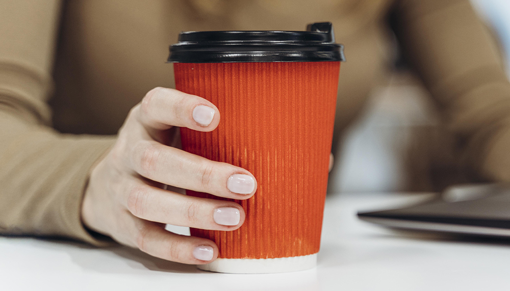 woman-holding-cup-coffee-work
